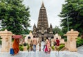 Indian people walking on bare foot to Mahabodhi Temple for praying and pilgrim while raining at Bodh Gaya, Bihar, India. Royalty Free Stock Photo