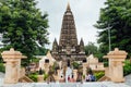 Indian people walking on bare foot to Mahabodhi Temple for praying and pilgrim while raining at Bodh Gaya, Bihar, India. Royalty Free Stock Photo