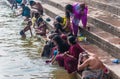 Indian people wash themselves in the river Ganges