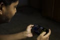 an Indian person is using youtube application in smartphone in a dark room with selective focus Royalty Free Stock Photo