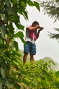 Indian photographer taking pictures in forest