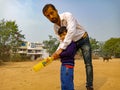 an indian play school male teacher giving training for cricket at ground in India January 2020