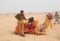 Indian police man holding the camel in Rajasthan