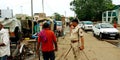 Indian police officer standing during duty at rickshaw stand railway station