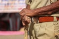 Indian policeman close to Police stick and uniform, Indian policeman & x28;CRPF& x29; with bamboo sticks patrols,hand in