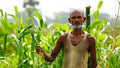 Indian poor farmer standing in agricultural field