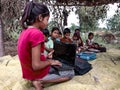 indian poor girl giving training about laptop computer system at village area open class in india January 2020 Royalty Free Stock Photo