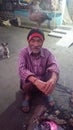 a indian poor men wiht a small dog and hen