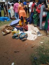 Indian Poor Mother and Child selling Coconut, Lime, Banana and Flowers or Puja Items in a Roadside near the Temple