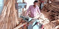 An indian poor village worker making furniture at wooden workshop