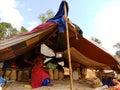 an indian poor woman seating inside the huts at sky background in india January 2020