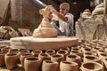 Indian potter making clay pots on pottery wheel in Bikaner. Rajasthan. India