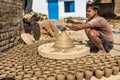 Indian potter making clay pots on pottery wheel in Bikaner. Rajasthan. India