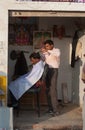 Indian professional hairdresser in street salon
