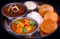 Indian Punjabi meal-curries served with rice and puri Royalty Free Stock Photo