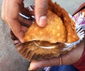 Indian punjabi samosa in hand of girl