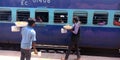 Indian railway food vendor selling samosa in front of train