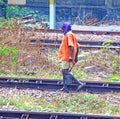 Indian railway worker walking along tracks