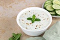 Indian raita sauce with greek yogurt, cucumber and mint on a yellow background. Top view, copy space. Royalty Free Stock Photo