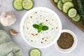 Indian raita sauce with yogurt, cucumber and herbs on a gray background. Top view. Indian food. Royalty Free Stock Photo