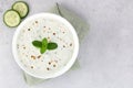 Indian raita sauce with yogurt, cucumber and mint on a gray background. Top view. Indian food. Greek tzatziki sauce. Royalty Free Stock Photo