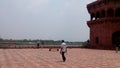 Indian red Mahal ground inTaj Mahal. Red ground front of red Mahal some people walk rad Mahal ground of Taj Mahal. Beautiful .