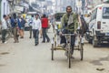 indian rickshaw driver looks for passengers in the old part of New Delhi