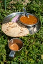 Indian Roti-Sabzi ( Indian bread and vegetable curry) food platter and tea in the outdoor Royalty Free Stock Photo