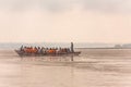 Indian rower man training his orange cloth rower men on the boat that floating over the Ganges Ganga river in Varanasi.