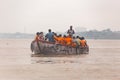 Indian rower man training his orange cloth rower men on the boat that floating over the Ganges Ganga river in Varanasi.