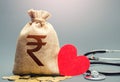 Indian rupee money bag and stethoscope. Health life insurance financing concept. Subsidies. Reforming and preparing for new Royalty Free Stock Photo