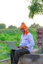 Indian rural farmer using laptop