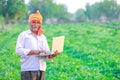 Indian rural farmer using laptop