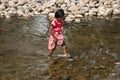 Indian rural girl is crossing a river