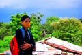 Indian rural school student wears uniform and wears face mask for coronavirus safety protection. with background of greenery and