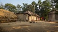Indian rural village in West Bengal with mud huts, poultry and tribal women