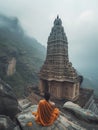 an indian saint sitting on big hindu temple