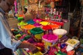 Indian Salesman in front of his shop selling colorful powder for Holi Festival, Jaipur, Rajasthan, India