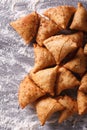 Indian samosa pastry on a floured table. vertical top view
