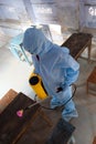 Indian sanitary worker conducting disinfection of the interior during the COVID-19 pandemic