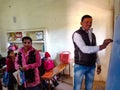 an indian school class teacher writing on chalkboard during class in india January 2020