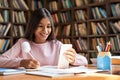 Indian school girl holding phone distance learning using mobile application. Royalty Free Stock Photo