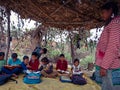 indian children studying at open area class village about laptop system in India January 1, 2020