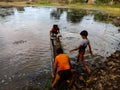 indian children studying at open area class village about laptop system in India January 1, 2020