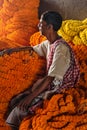 Indian seller with flower garland on Flower market at Mallick Ghat in Kolkata. India Royalty Free Stock Photo