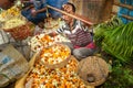 Indian seller weighs flowers by scales on Flower market at Mallick Ghat in Kolkata. India Royalty Free Stock Photo