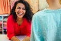 Indian seller women in red kurta stand in her studio showroom