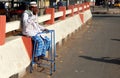Indian senior physically challenged man seeking help / alms on a busy road. Royalty Free Stock Photo