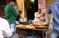 An Indian shop owner selling street food in a street in Pushkar, India