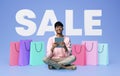 Indian Shopaholic Guy Making Online Purchase On Tablet, Blue Background Royalty Free Stock Photo